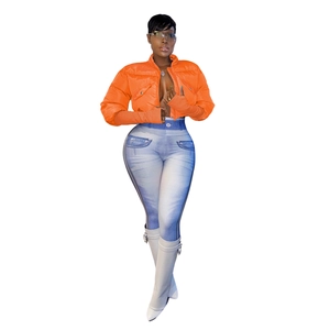 Detail of bright orange puffer jacket with utility pockets and denim print leggings