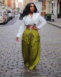Detail of olive green cargo pants with detachable pockets and satin finish fabric