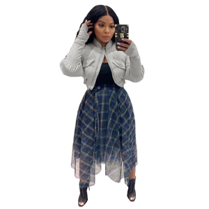 Detail of short stand-collar winter puffer jacket paired with a plaid mesh skirt