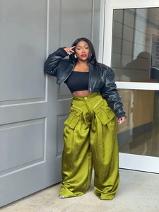 Detail of olive green cargo wide-leg pants with large functional pockets and 3D design