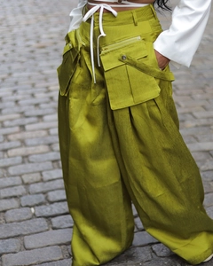 Detail of wide-leg cargo pants featuring large pockets and fine ribbed fabric texture