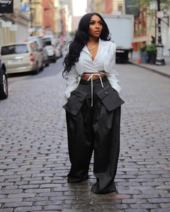 Close-up of high-waist wide-leg utility trousers with large flap cargo pockets