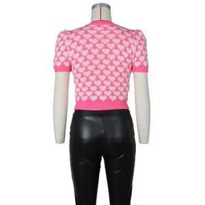 Rear view of knit top featuring heart pattern and black leather-look slim pants