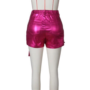 Close-up of metallic pink high-stretch shorts with back pockets and elastic waistband