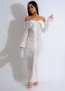Detailed view of the white off-shoulder dress with vertical pleated wavy textures
