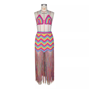 Close-up of handmade crochet waves and colorful fringe detail on bohemian beach skirt