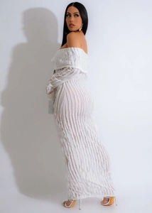 Detail of off-shoulder dress featuring textured vertical embossed ripple fabric and long sleeves
