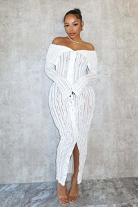 Detail view of white off-shoulder long sleeve dress featuring wave texture and front buttons