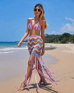 Detail of colorful crochet knit patterns and long fringe tassels on a beach skirt set