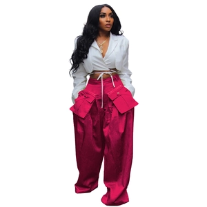 Detail of cargo wide-leg pants featuring large functional 3D flap pockets and high-waist design