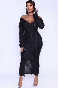 Detail of black off-shoulder bodycon maxi dress featuring ruffled wave texture and buttons