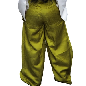Detail of olive green wide-leg trousers showing back seams and subtle fabric texture