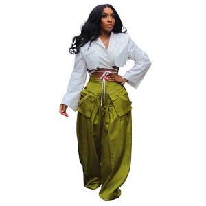 Detail of high-waist olive cargo pants with large pockets and wide-leg silhouette