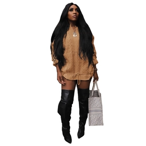 Detail of cable knit texture and adjustable drawstring hem on oversized khaki sweater