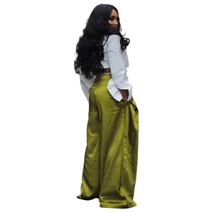 Detail view of high-waist olive wide-leg trousers and white shirt on a model side profile