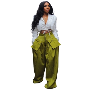 Detail of high-waist olive green wide-leg trousers with large cargo flap pockets