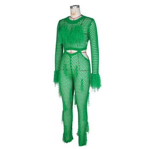 Detail of green crochet knit jumpsuit with lush faux mink fur fringes on cuffs and chest