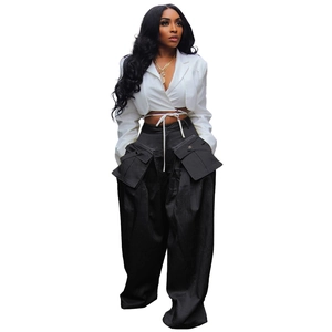 Detail of high-waist black wide-leg cargo pants with 3D detachable flap pockets