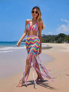 Women's crochet beach set with zigzag patterns and long fringe skirt on beach