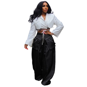 Detailed view of women's crop top with waist ties and wide-leg cargo pants with 3D pockets
