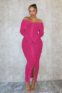 Detailed close-up of pink off-shoulder knit dress with vertical texture and button-front