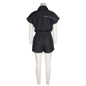 Detail view of denim romper back featuring white distressed raw edges and elastic waist