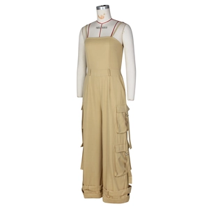 Detail view of khaki strapless jumpsuit featuring functional cargo pockets and utility belts