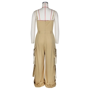 Detail of khaki cargo jumpsuit featuring back zipper closure and functional utility pockets
