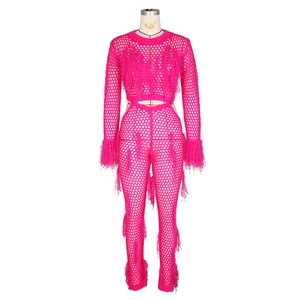Close-up of rose pink mesh crochet set with fluffy feather fringe on sleeves and pants
