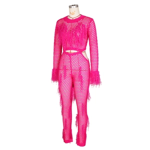Detail of rose pink openwork crochet knit set with feather fringe on cuffs and legs