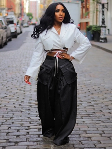 Fashion set featuring white cropped tie-waist blazer and black wide-leg trousers with large pockets