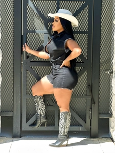 Detail of black denim romper with frayed hem and embroidered western cowgirl boots