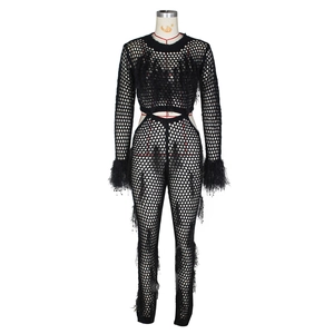 Close-up of black hollow mesh knit set with elegant faux fur feather tassels detail