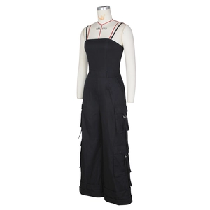 Detail of black strapless cargo jumpsuit showing side utility pockets and buckle accents