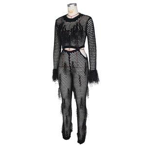 Close-up of black mesh jumpsuit featuring feather cuffs and sexy hollow-out waist design