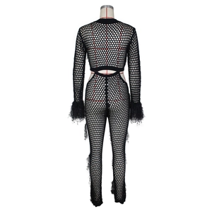 Detail of mesh cutout jumpsuit featuring fluffy faux mink fur trim on long sleeves