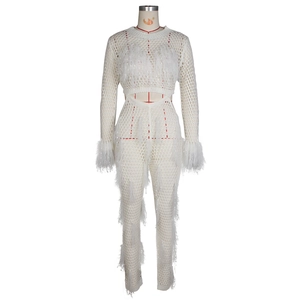 Detailed close-up of white crochet two-piece set with elegant feather fringe accents