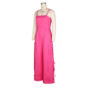 Detail of pink cargo jumpsuit showing large utility pockets and adjustable straps