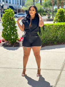Women's black sleeveless denim romper with button-up collar and raw hem fringe details