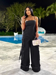Detail of black strapless cargo jumpsuit with utility pockets and wide-leg silhouette