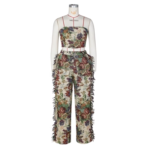 Detail of floral jacquard fabric texture and colorful side tassels on stylish trousers