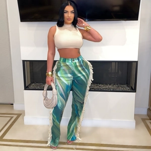 Detailed view of fashion trousers with abstract print and long white side fringe details