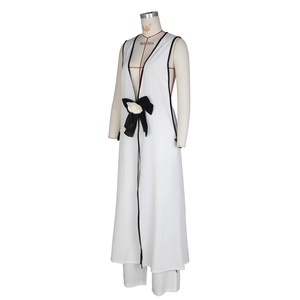 Detail of a black and white two-piece suit with a satin bow and 3D flower accent