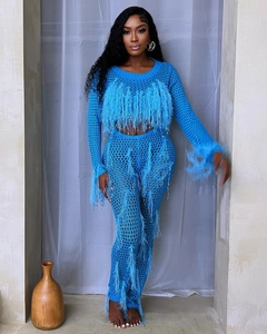 Detail view of the bright blue crochet mesh texture and feather fringe trim on the outfit