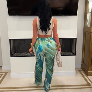 Detailed back view of printed boho trousers with side tassels and geometric pattern