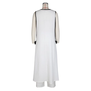 Detail of white sleeveless top with black bow accents and contrasting trim decoration