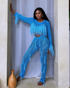 Detailed close-up of bright blue hollow knit set with fringe and feather trim detail