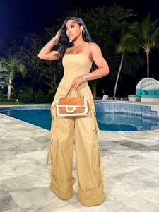 Detail view of khaki cargo jumpsuit with functional large pockets and side strap accents