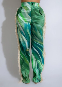 Detail of high waisted green wave print wide leg pants with beige side fringe decor