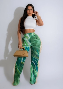 Detail showing the white fringe trim and green marble print on high waist trousers